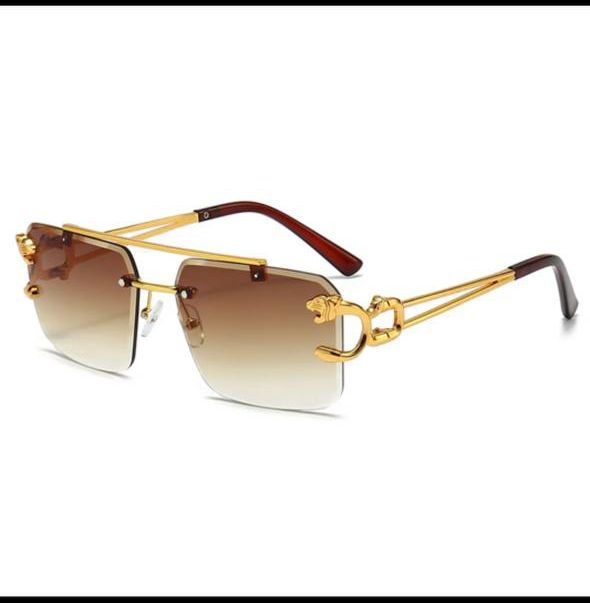 Gold-framed sunglasses with gradient lenses on a white background