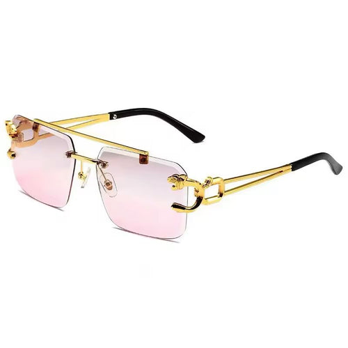 Gold-framed sunglasses with pink lenses on a white background
